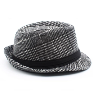 Detailed macro view of classic British plaid pattern and black grosgrain ribbon on fedora