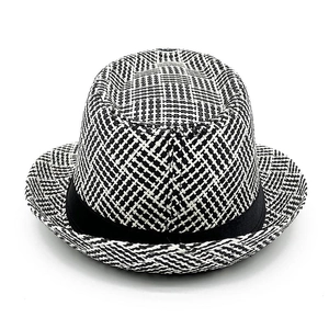 Close-up of the black and white cross-weave texture on a vintage straw fedora sun hat