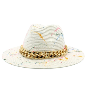 Panama straw hat with artistic graffiti, wide brim, and a chunky gold acrylic chain