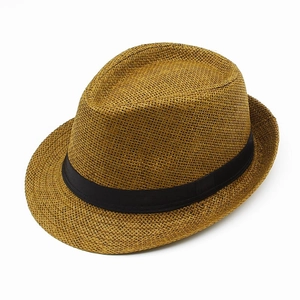 Detail of the woven texture and black ribbon trim on a brown straw fedora hat