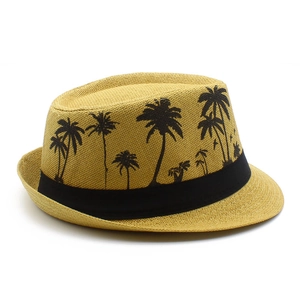 Detail of the woven straw texture and black palm tree print on this summer fedora sun hat