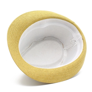 Detail shot of straw hat interior with 100% paper material label and size 58 tag