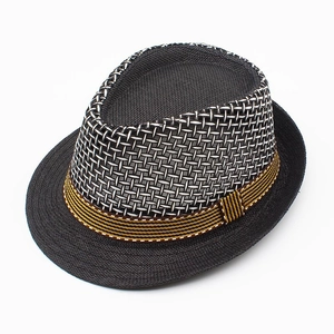 Detailed view of woven straw sun hat with breathable mesh crown and brown decorative band