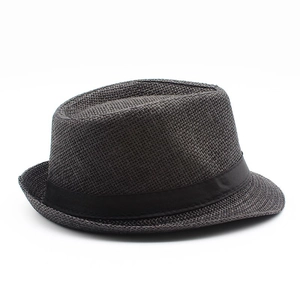 Detailed top view of dark grey woven straw fedora hat with a black band on white background
