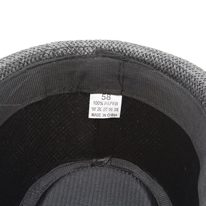Macro shot of 100% paper material label and size 58 tag on a grey straw fedora hat
