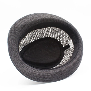 Detail view of woven paper fiber fedora hat interior with size tag and sweatband
