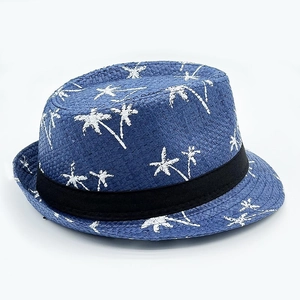 Detail of blue straw fedora hat featuring white palm tree patterns and black ribbon band