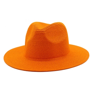 Detailed close-up of vibrant orange woven straw Panama hat with fine texture