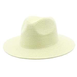 Macro shot of spiral woven texture on a cream straw fedora hat for summer sun protection
