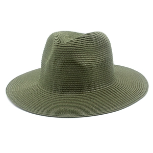 Detailed texture of dark green woven straw panama hat with wide brim and crown crease