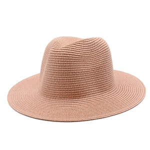 Detailed view of the fine woven straw texture on this pale pink wide-brimmed Fedora hat