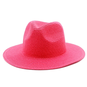 Detail of fuchsia woven sun hat showing fine straw texture and classic fedora crown