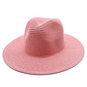 Close-up of the delicate pink straw weave and wide brim texture of this sun hat