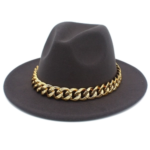 Detail of dark grey felt jazz hat with a chunky gold chain strap on flat brim