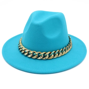Detail of the turquoise fedora hat with a decorative gold Cuban chain on the band