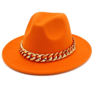 Detailed view of a bright orange fedora hat featuring a stylish thick gold chain decoration