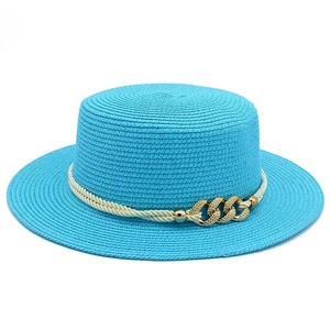Detail of blue straw sun hat with woven rope band and golden chain metal buckle