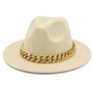 Detail of beige wool fedora hat featuring a chunky gold chain and classic pinched crown