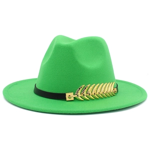 Close-up of green fedora hat featuring black leather band and gold feather metal accessory