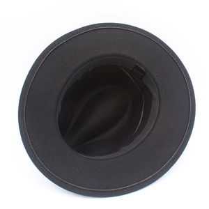 Detail shot of black fedora inner structure with sweatband and fabric care label