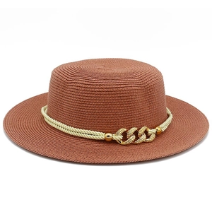 Detail of auburn straw boater hat featuring a cream rope band and gold metal chain links