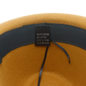 Detailed interior of yellow wool fedora hat showing adjustable sweatband and fabric label