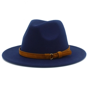 Detail of navy blue wool fedora hat featuring a brown leather band and gold buckle