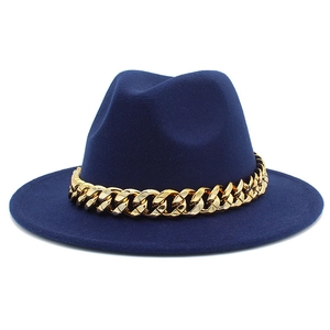 Detailed texture of navy wool felt fedora hat featuring a chunky gold acrylic chain