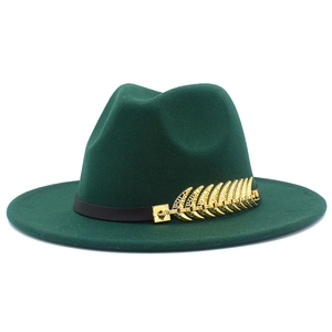 Detail of dark green fedora hat featuring a black leather band and golden leaf metal buckle