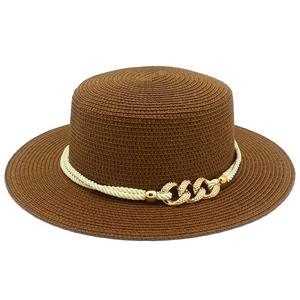 Detail of brown straw jazz hat featuring cream twisted rope and gold metal chain buckle decor
