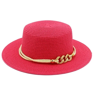 Close-up of deep pink boater hat with beige twisted rope and golden chain buckle decoration