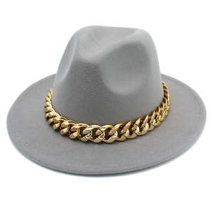 Detail of light gray felt fedora hat with chunky gold chain decoration and flat brim