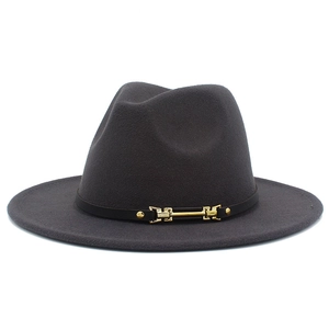 Detail of grey wool fedora hat featuring a black leather band and gold metal buckle