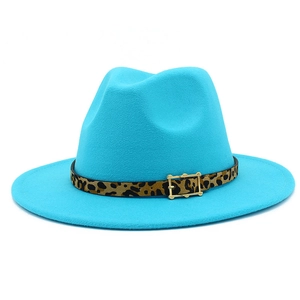 Detail of teal fedora hat featuring leopard print leather band and golden buckle