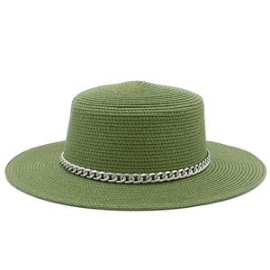 Close-up of green straw boater hat featuring fine woven texture and a bold silver chain band