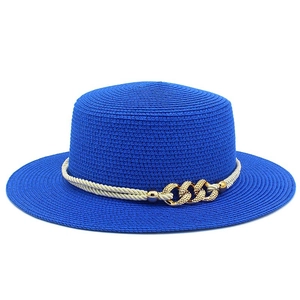 Detail of blue straw sun hat featuring a gold metal chain buckle and rope band