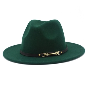 Close-up of dark green wool fedora hat featuring a thin black leather band and gold buckle