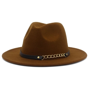 Close-up of brown wool fedora hat featuring black leather band and gold metal chain link