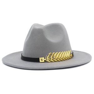 Detail of gray wool fedora hat with black leather band and golden leaf metallic accent
