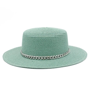 Detailed texture of mint green straw sun hat with decorative silver metal chain link