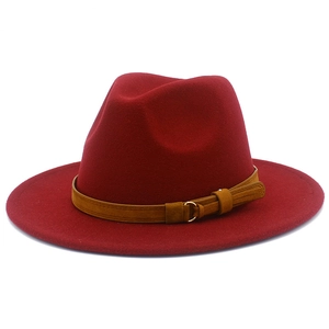 Detailed shot of the wine red wool fedora featuring a brown leather band and gold buckle