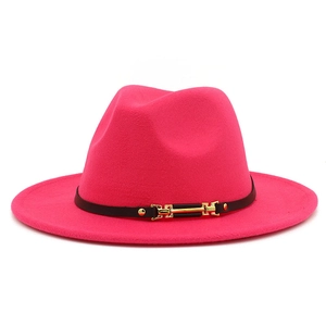 Detail of fuchsia wool fedora with black leather belt and gold buckle accent