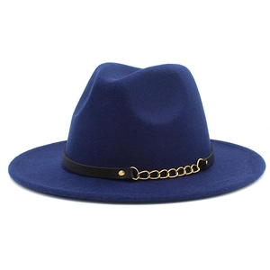 Detail of royal blue wool fedora hat featuring a black leather band and gold chain accent