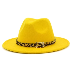 Detail of yellow felt jazz hat featuring leopard print band and golden metal buckle