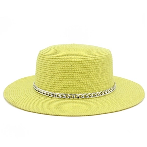 Detail of yellow straw hat with a bold silver metal chain and fine woven texture