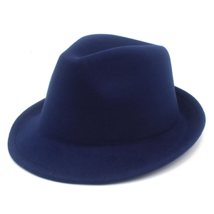 Detail of the navy blue fedora hat showing textured wool fabric and classic crown dent