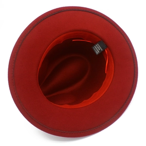 Top view of red wool felt fedora hat showing internal lining and material label