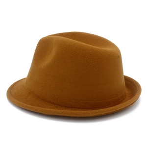 Macro detail of brown wool fedora hat featuring pinch front crown and textured felt fabric