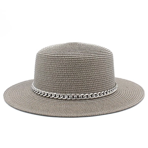 Detail of taupe straw flat top hat featuring fine weave texture and silver chain trim