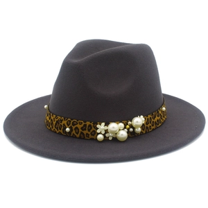 Detail of dark grey wool fedora featuring leopard print band with pearls and floral accents